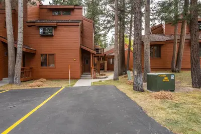 a parking lot in front of a house at Updated 2 Bedroom and Loft 2 Full Bathroom Woodlands #51Just Steps to Shuttle Close to Golf Course in Mammoth Lakes