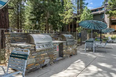 a patio with an outdoor grill and an umbrella at Summit #256 - Top Floor Summit 1 Bedrm 1 Bathrm Condo Just steps too Little Eagle Lodge Sleeps 4 in Mammoth Lakes