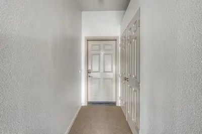 an empty corridor with a white door in a room at Tavern Inn #39 in Olympic Valley