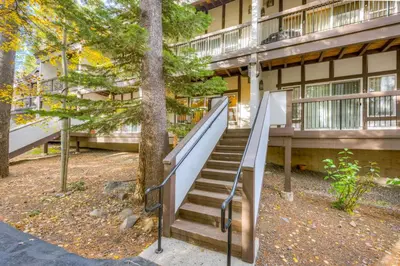a staircase in front of a building with trees at Tavern Inn #39 in Olympic Valley