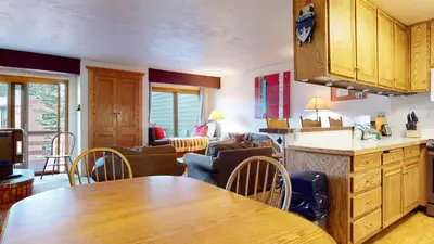 a kitchen and living room with a table and chairs at Lakeview Villas #28 condo in Mammoth Lakes