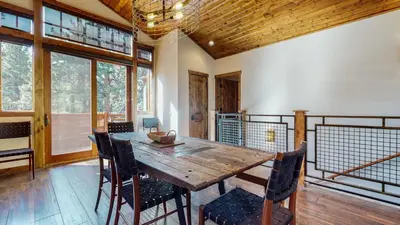 a dining room with a wooden table and chairs at Graystone #2024 home in Mammoth Lakes