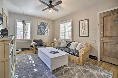 a living room with a couch and a ceiling fan at Hot Tub and Walk to Midtown! Reno Retreat in Reno