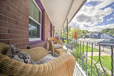 a porch with two wicker chairs on a balcony at Hot Tub and Walk to Midtown! Reno Retreat in Reno