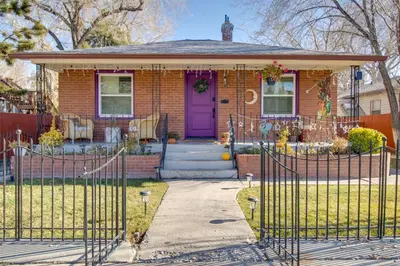 a house with a purple door and a fence at Hot Tub and Walk to Midtown! Reno Retreat in Reno