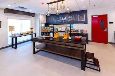 a lobby of a restaurant with a counter and a bar at Hampton Inn Selma, Ca in Selma