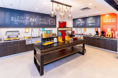 a restaurant kitchen with a counter and a counter at Hampton Inn Selma, Ca in Selma