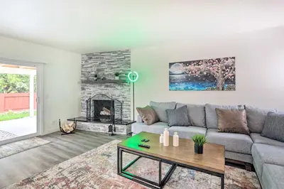 a living room with a couch and a fireplace at Relax Fireside and Play Pool! Home 4 Mi to Dtwn Reno in Reno
