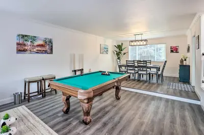 a living room with a pool table in it at Relax Fireside and Play Pool! Home 4 Mi to Dtwn Reno in Reno