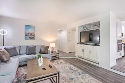 a living room with a couch and a tv at Relax Fireside and Play Pool! Home 4 Mi to Dtwn Reno in Reno