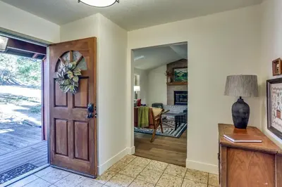 a hallway with a door leading to a dining room at Pet-Friendly Escape with Game Room and Fire Pit! in North Fork