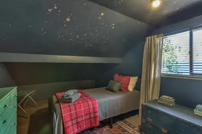 a bedroom with a bed in a room with a window at Pet-Friendly Escape with Game Room and Fire Pit! in North Fork