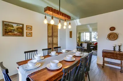 a dining room with a wooden table and chairs at Pet-Friendly Escape with Game Room and Fire Pit! in North Fork
