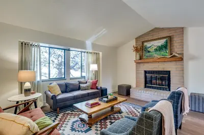 a living room with a couch and a fireplace at Pet-Friendly Escape with Game Room and Fire Pit! in North Fork