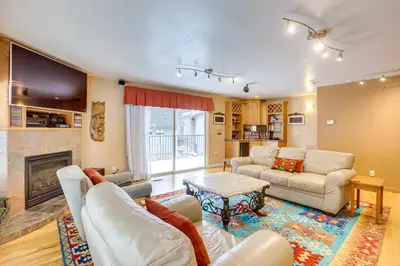 a living room with white furniture and a fireplace at 3 Mi to Skiing! Incline Village Retreat with Sauna in Incline Village