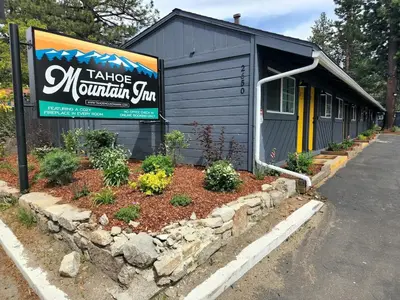 a building with a sign that reads take a mountain sing at Tahoe Mountain Inn in South Lake Tahoe