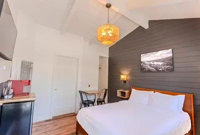 a bedroom with a bed and a table in it at Tahoe Mountain Inn in South Lake Tahoe