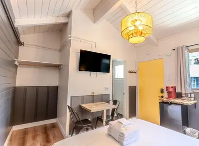 a dining room with a table and a tv on the wall at Tahoe Mountain Inn in South Lake Tahoe