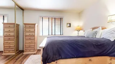 a bedroom with a large bed and a dresser at Mammoth Sierra Townhomes #18 condo in Mammoth Lakes