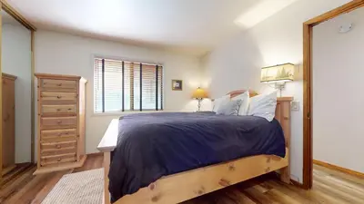 a bedroom with a large bed and a window at Mammoth Sierra Townhomes #18 condo in Mammoth Lakes