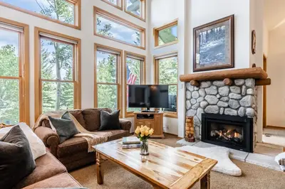a living room with a fireplace and a tv at Updated 3 Bedroom 3 Bathroom Snowcreek Phase V #884, Sleeps 6 in Mammoth Lakes