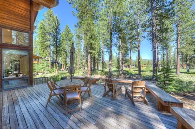 a wooden deck with a table and chairs at Sierra Vista in Truckee