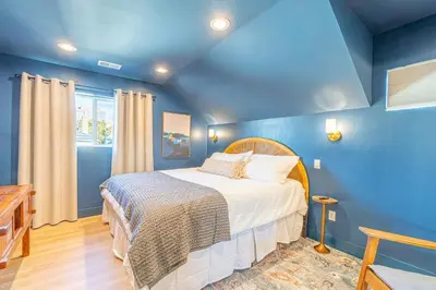 a blue bedroom with a bed in a room at Luxury 4-bed home in Riverside Heights! in Reno
