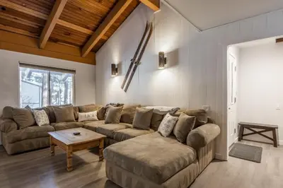 a living room with a couch and a table at Horizons IV 180 New Luxurious Listing Fully Remodeled 2 Bedrm Plus Loft 2 and a half Bathrm Sleeps 8 in Mammoth Lakes