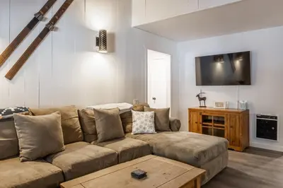 a living room with a couch and a table at Horizons IV 180 New Luxurious Listing Fully Remodeled 2 Bedrm Plus Loft 2 and a half Bathrm Sleeps 8 in Mammoth Lakes