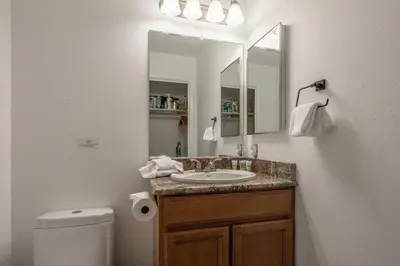 a bathroom with a sink and a mirror and a toilet at Horizons IV 180 New Luxurious Listing Fully Remodeled 2 Bedrm Plus Loft 2 and a half Bathrm Sleeps 8 in Mammoth Lakes