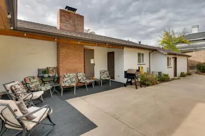 a patio with chairs and a grill and a house at Game Room and Patio Charming Jackson Retreat! in Jackson