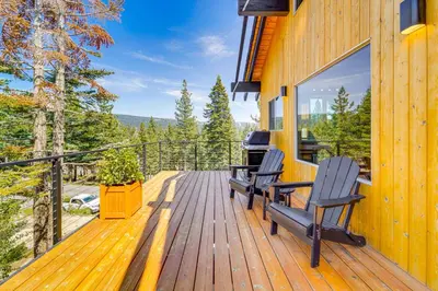 a wooden deck with two chairs on the side of a house at 4 Mi to Slopes! Hot Tub Haven with Lake Tahoe Views in Incline Village