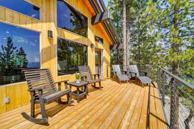 a wooden deck with chairs and a table at 4 Mi to Slopes! Hot Tub Haven with Lake Tahoe Views in Incline Village
