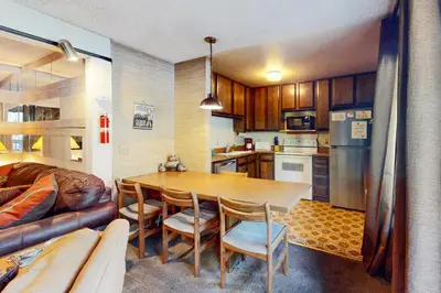 a kitchen and dining room with a table and a couch at Sherwin Villas 12 B in Mammoth Lakes