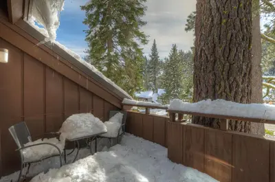 a fence covered in snow next to a tree at Granlibakken Gem - Unit 71 in Tahoe City