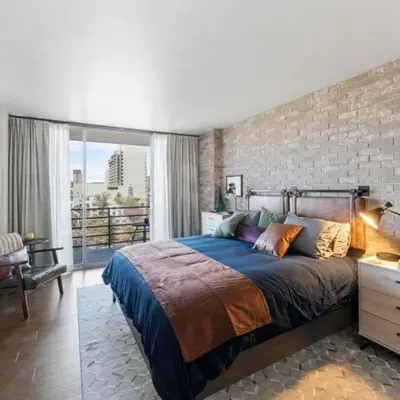 a bedroom with a large bed and a brick wall at Panorama Place in Reno