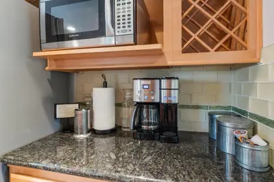 a kitchen counter with a microwave and a coffee maker at Reno Roost in Reno