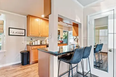 a kitchen with a counter and bar stools at Reno Roost in Reno