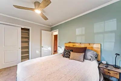 a bedroom with a bed with a ceiling fan at Reno Roost in Reno