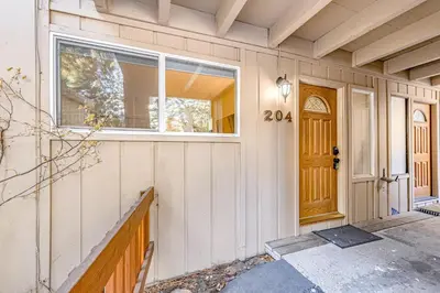 a front door of a white house with a window at Take Me to Tahoe in Incline Village