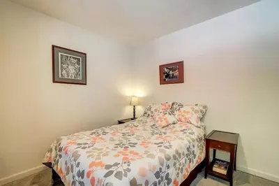 a bedroom with a bed and a table with a lamp at 1763 Saponi Street home in South Lake Tahoe