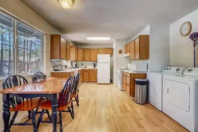 a kitchen with a table and chairs and a refrigerator at 1763 Saponi Street home in South Lake Tahoe