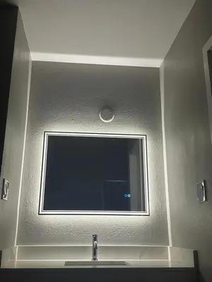 a large mirror above a sink in a bathroom at ROYAL MOTEL TRACY in Tracy
