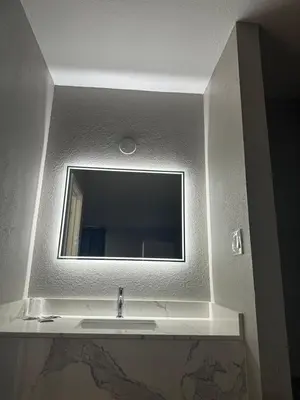 a bathroom with a sink and a mirror at ROYAL MOTEL TRACY in Tracy