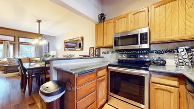 a kitchen with wooden cabinets and a stove top oven at Woodlands #11 condo in Mammoth Lakes