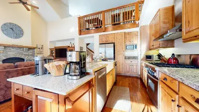 a kitchen with wooden cabinets and a counter top at Snowcreek VI The Lodges #1167 condo in Mammoth Lakes