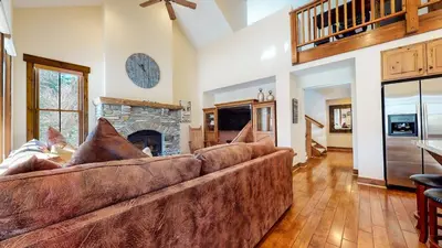 a living room with a couch and a fireplace at Snowcreek VI The Lodges #1167 condo in Mammoth Lakes