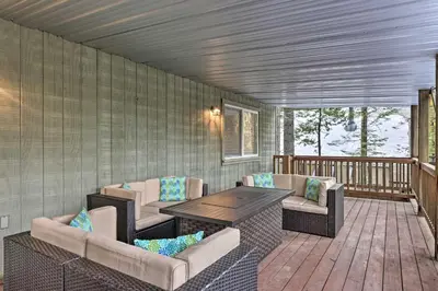 a porch with a table and chairs on a deck at Cold Springs Mountain Cabin Hot Tub and Generator in Cold Springs