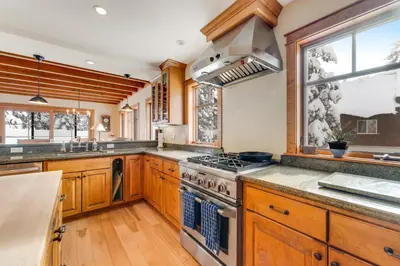 a kitchen with wooden cabinets and a stove top oven at Cabin in Soda Springs in Soda Springs