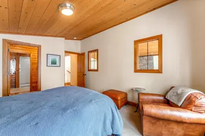 a bedroom with a bed and a chair at Cabin in Soda Springs in Soda Springs